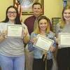 Comanche city manager Chuck Ralls stands with summer interns Shayson Hodges, Paiton Smith and Kelsi Evans. The interns were honored at last week’s city council meeting for their work for the city. Not pictured is Hunter Lassley.