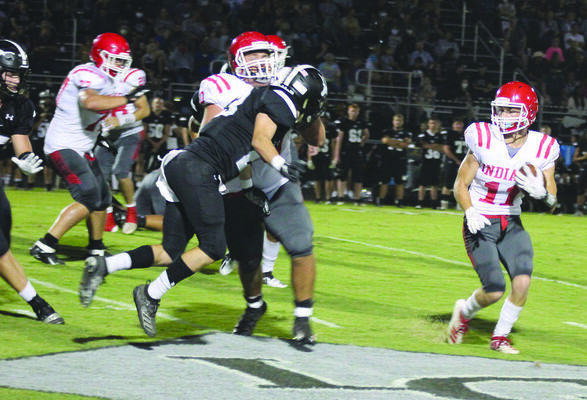 Comanche running back Gage Allie picks up a big block from Justin Jameson against Lone Grove last Friday.