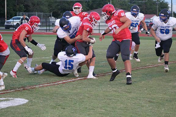 Comanche’s Bryson Evans tries to break through a tackle in the first quarter in the Indians’ 34-12 win over Healdton last Friday.